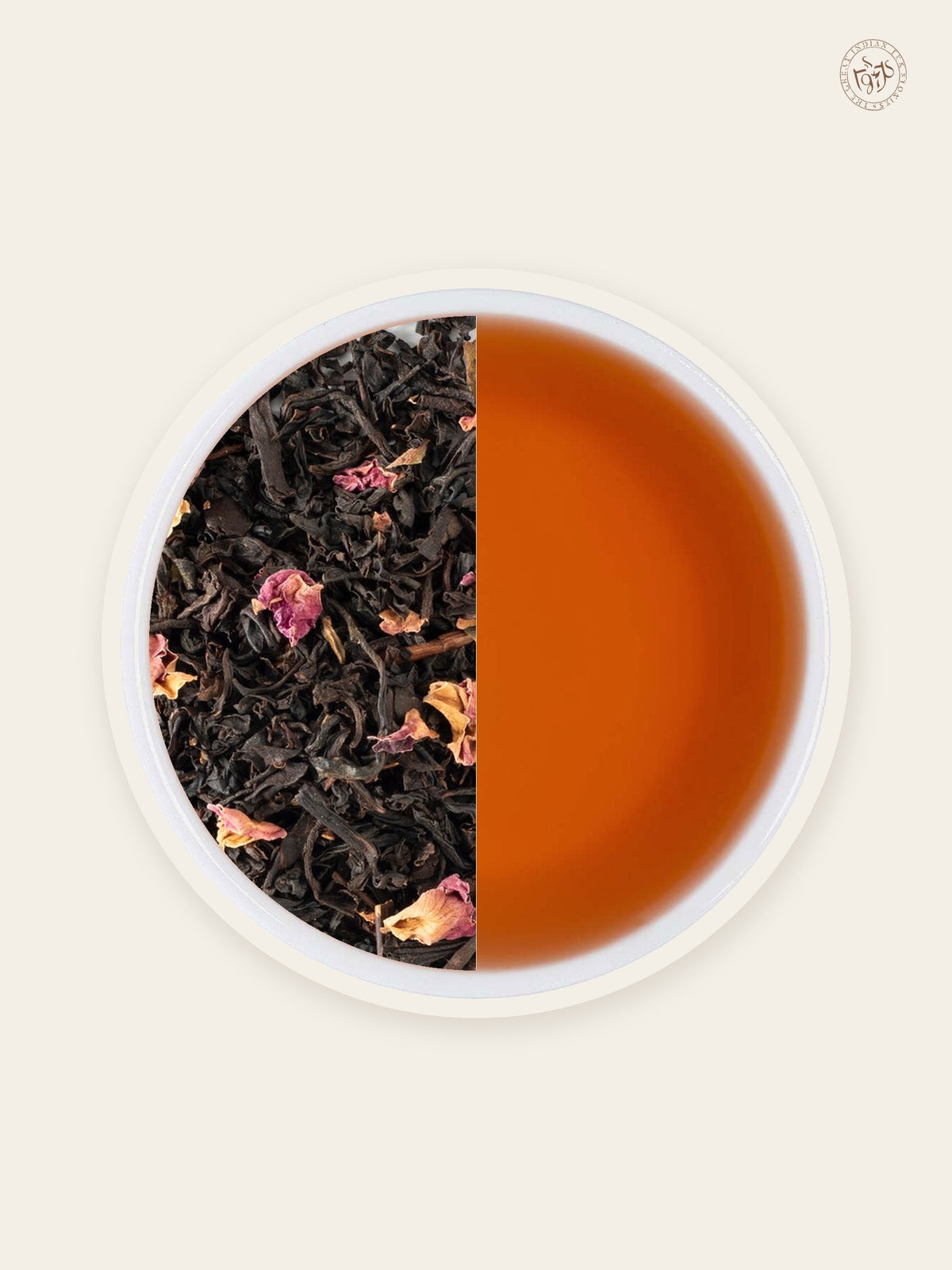 Rose black tea with rose petals beside warm blush-coloured tea liquor
