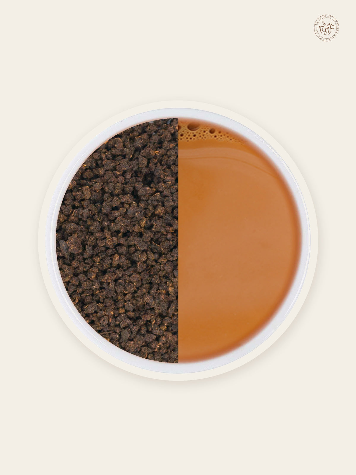 Premium blended CTC tea granules beside copper-coloured brewed chai